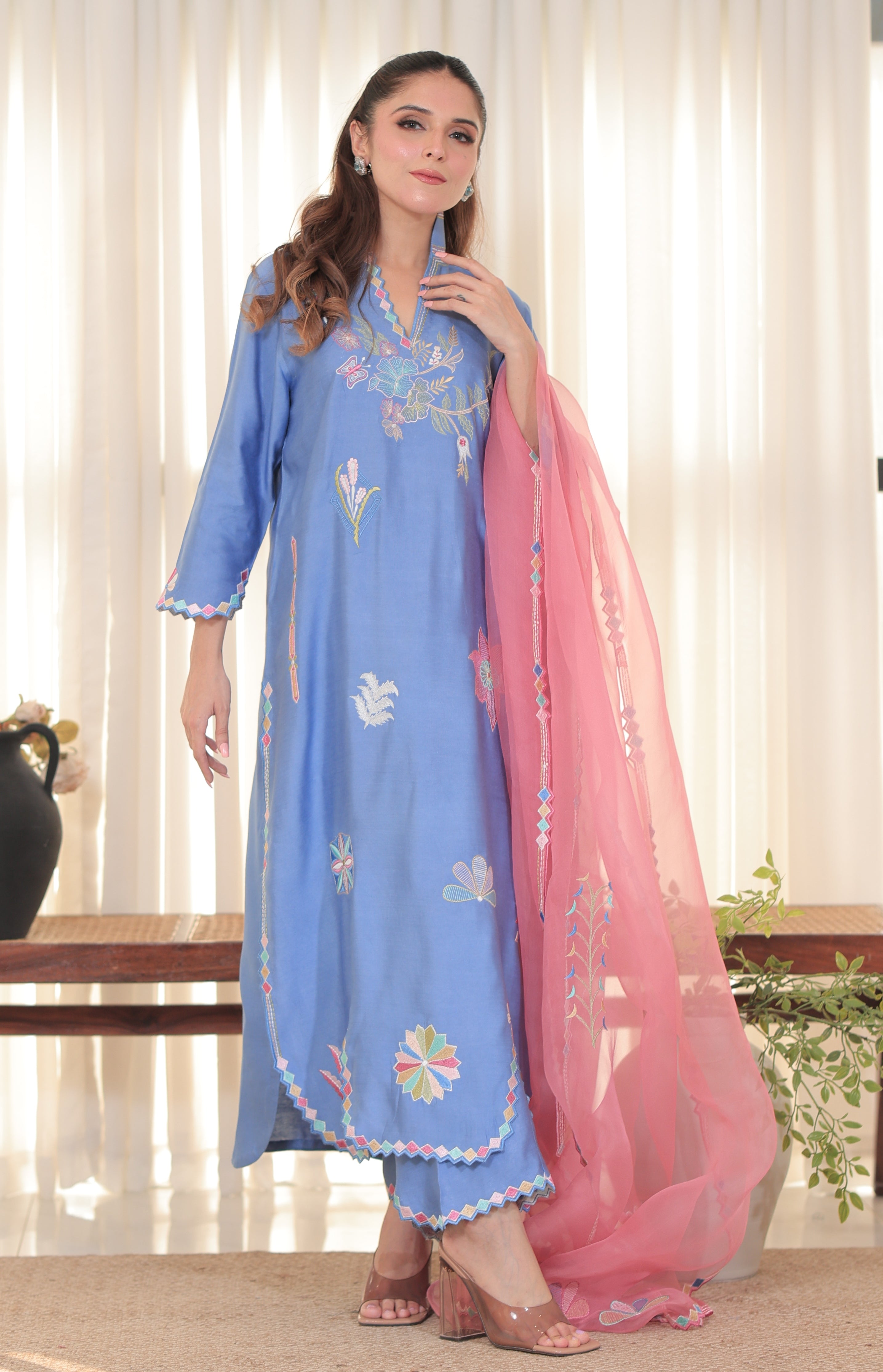 Model wearing Denim Rose outfit in blue pure khadi silk with multicolor hand embroidery and pink organza dupatta