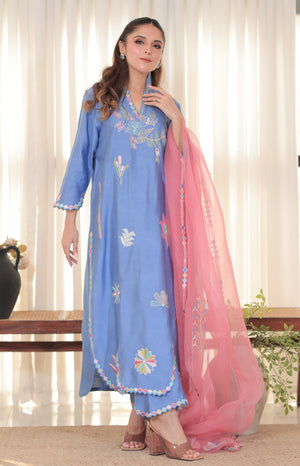 Model wearing Denim Rose outfit in blue pure khadi silk with multicolor hand embroidery and pink organza dupatta