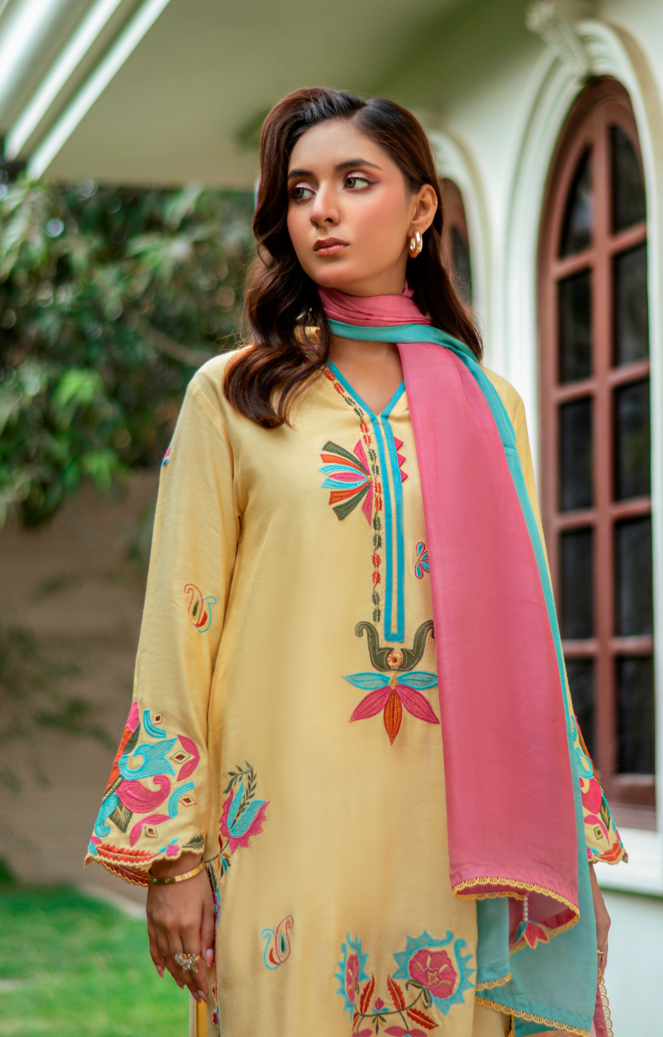 Model wearing Mango Sorbet khaddi silk outfit in mango yellow with multicolor embroidery and ombré pink-blue silk dupatta