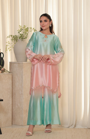 Model wearing Fairy Dust 2-piece ombré Sheesha silk outfit in pastel pink and mint green with hand embroidery and flared pants