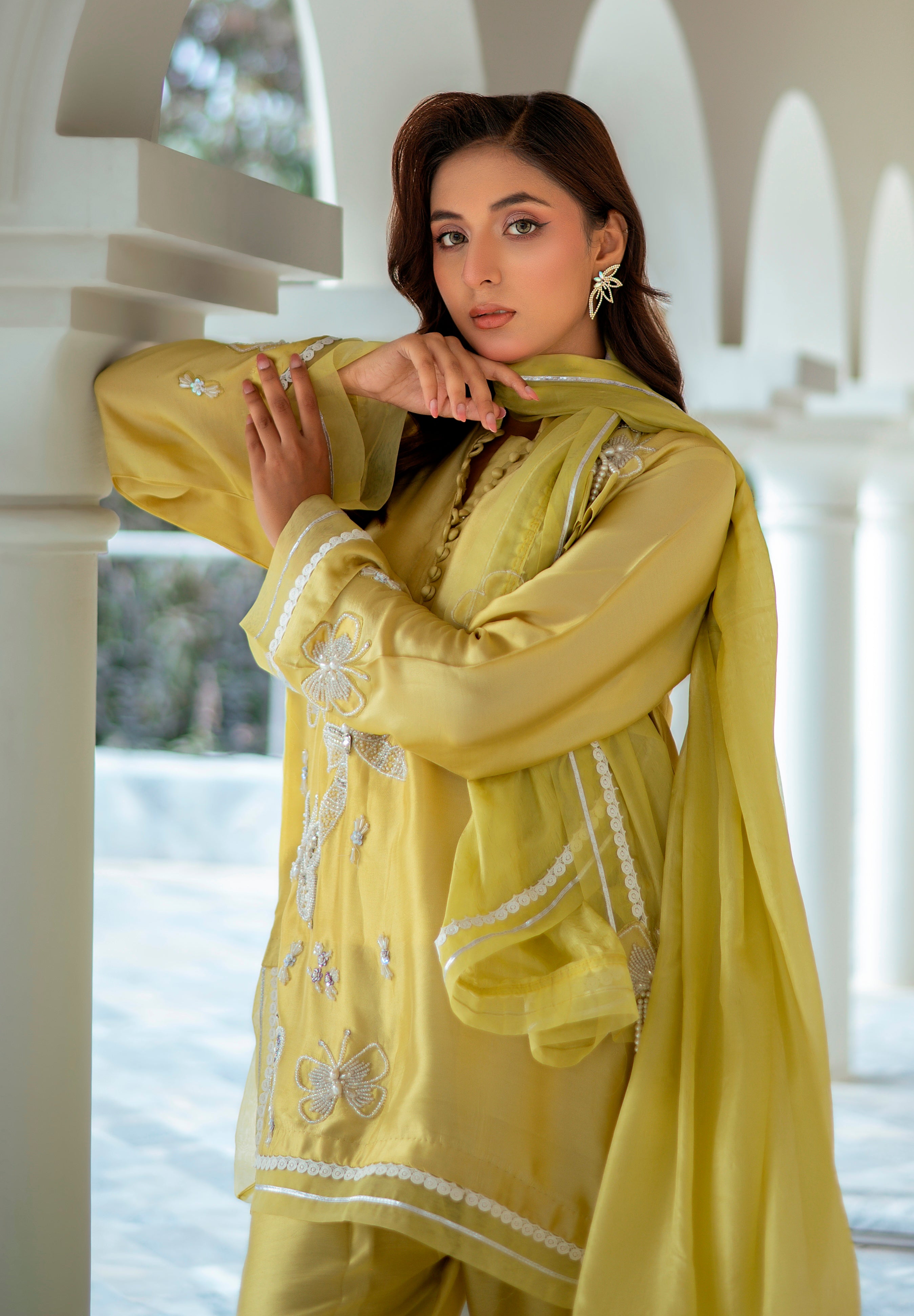 Model wearing Lime Luxe outfit in lemon yellow Sheesha silk with white hand embroidery and silk dupatta featuring organza and goti work