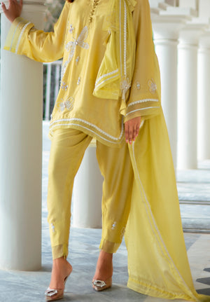 Elegant yellow Sheesha silk ensemble with floral hand embroidery, matching trousers, and lightweight silk dupatta with goti and organza accents