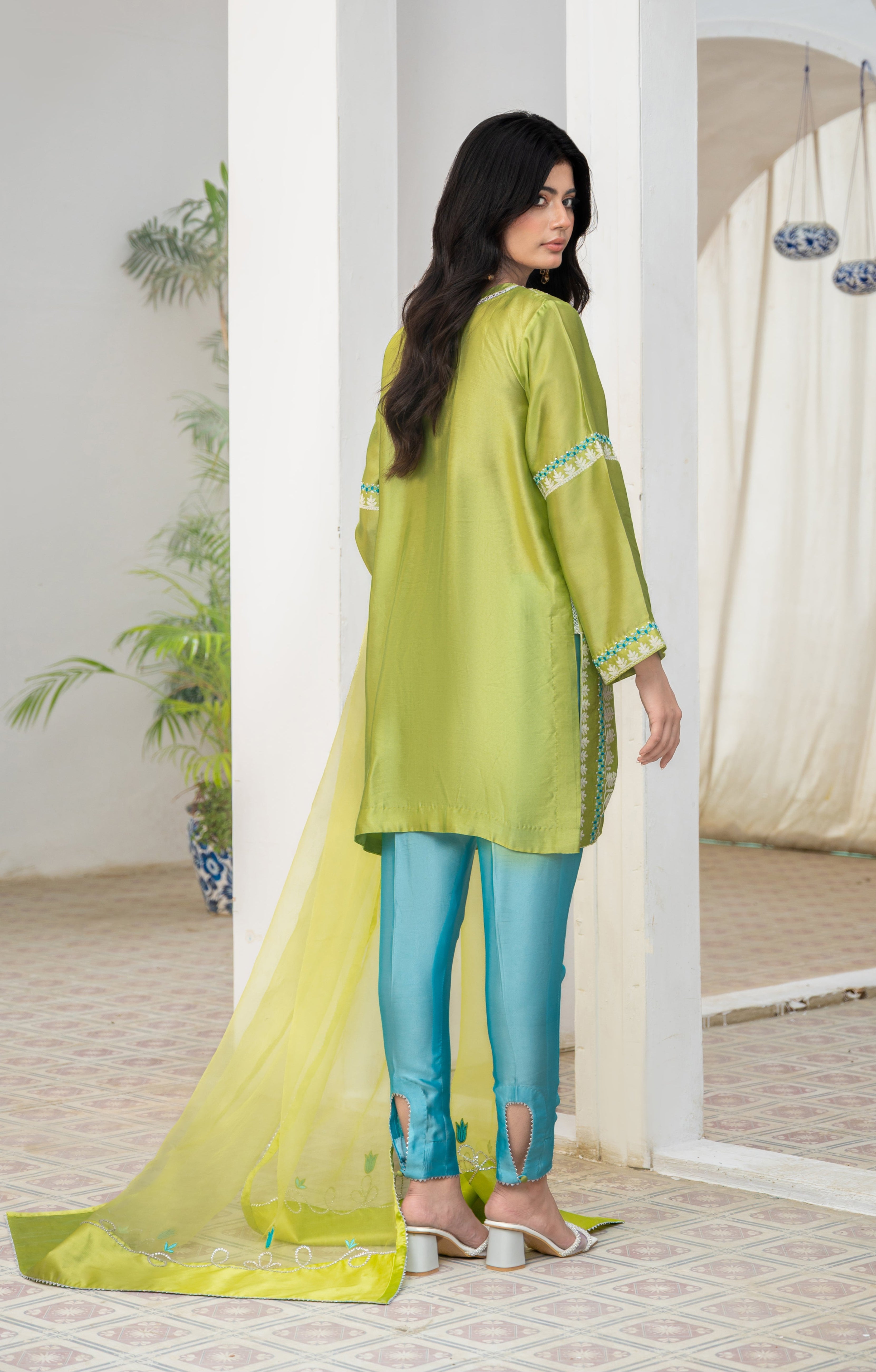 Woman in a green kurta of Sheesha Silk with Straight blue pants